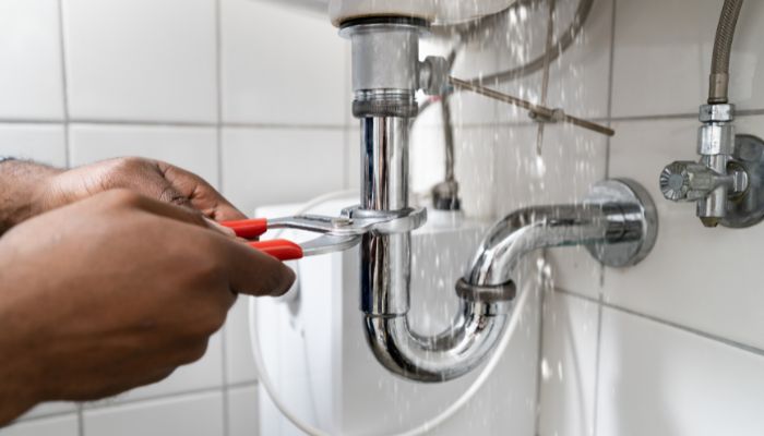 professional fixing a leaking bathroom sink - Elizabeth Drain and Plumbing Services | Elizabeth, NJ