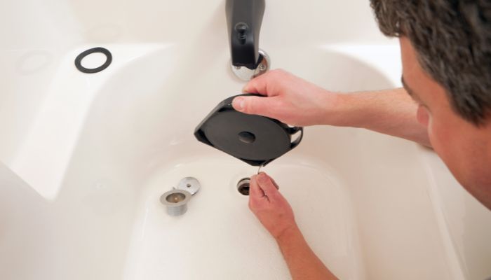 professional plumber fixing a clogged bathtub drain - Elizabeth Drain and Plumbing Services | Elizabeth, NJ