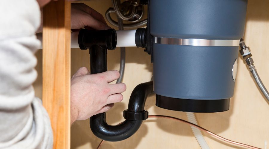 man fixing garbage disposal - Elizabeth Drain and Plumbing Services | Elizabeth, NJ