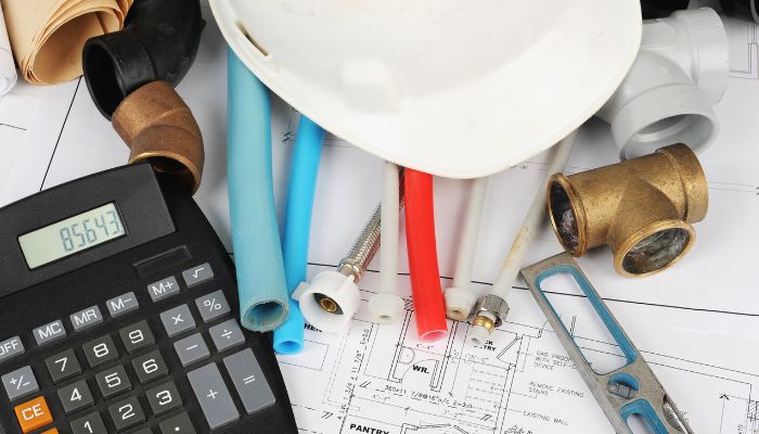 plumbing materials with a calculator - Elizabeth Drain and Plumbing Services | Elizabeth, NJ