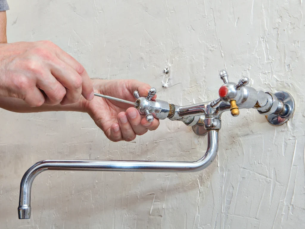 man fixing a faucet